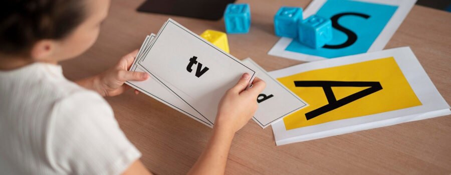 Little girl holding flashcards on her dyslexia treatment